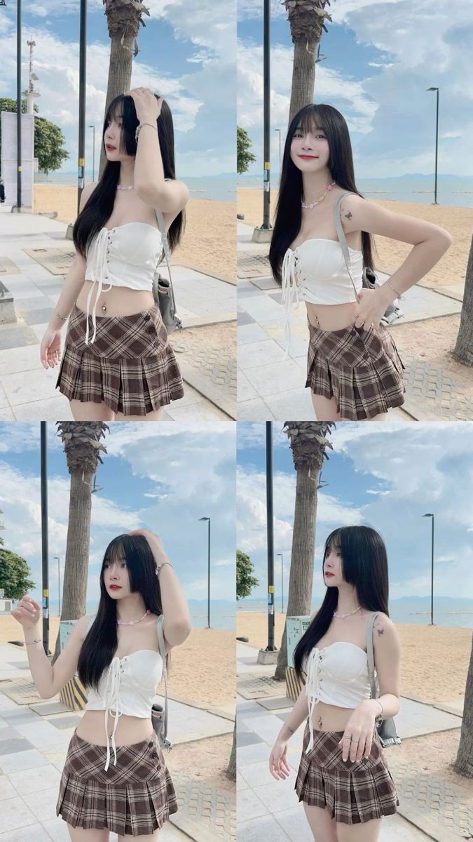 Ảnh gái trẻ mặc áo crop top trắng và chân váy kẻ sọc nâu