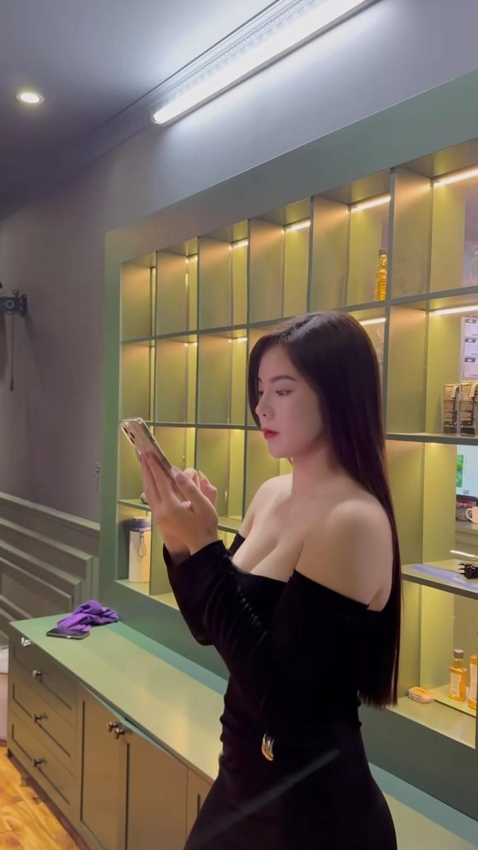 Cô gái mặc áo đen trong tiệm ánh sáng vàng ấm áp