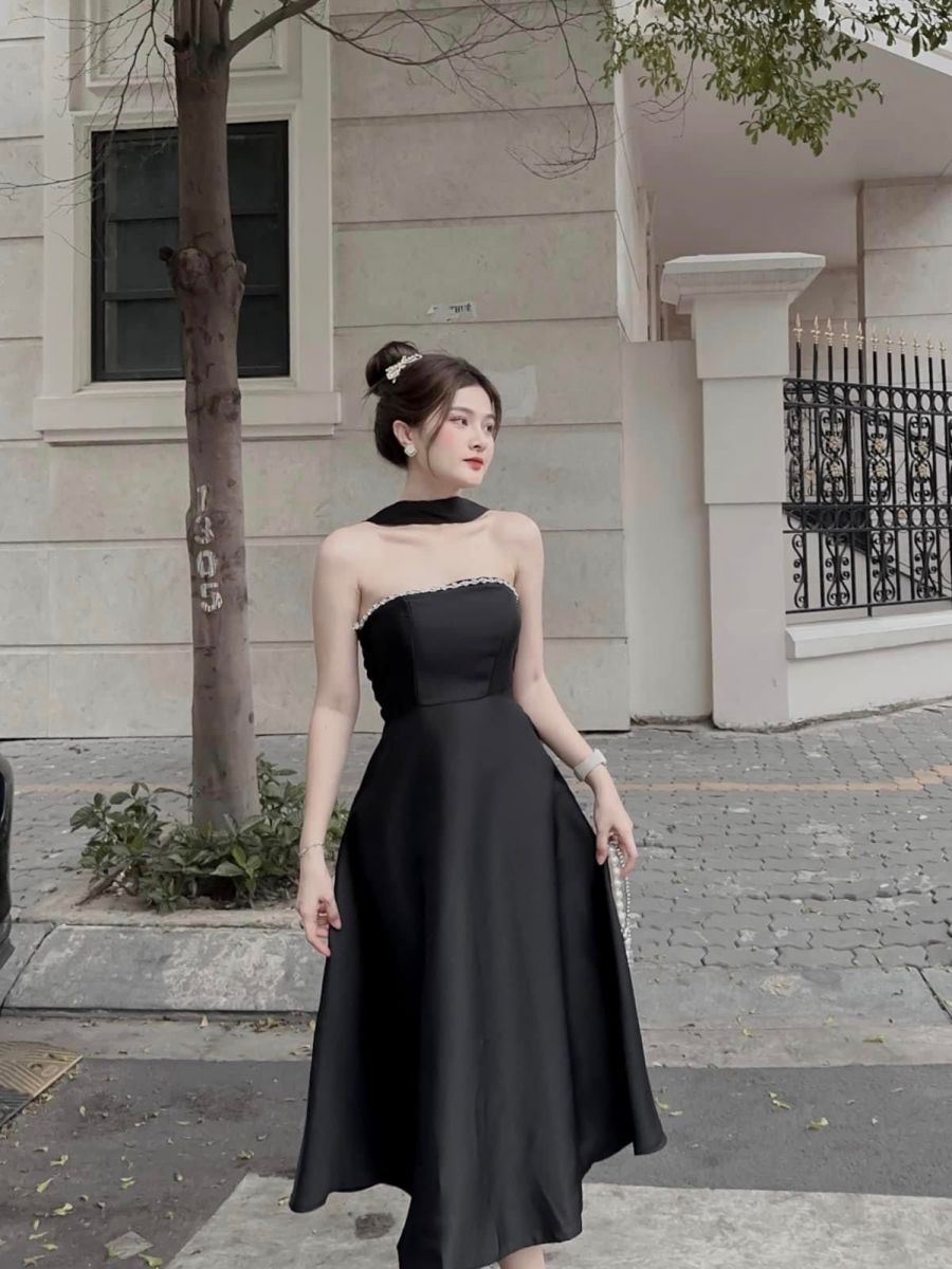 Cô gái mặc váy đen thanh lịch trên vỉa hè