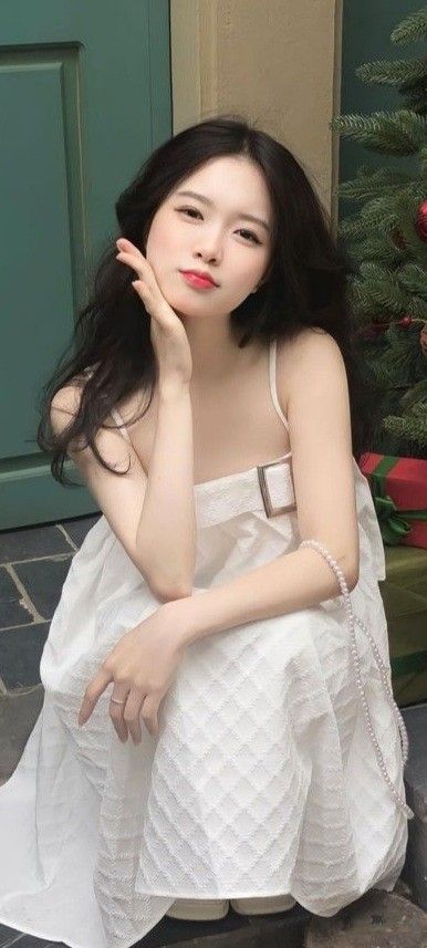 Cô gái xinh đẹp mặc váy trắng bên bức tường màu sắc rực rỡ