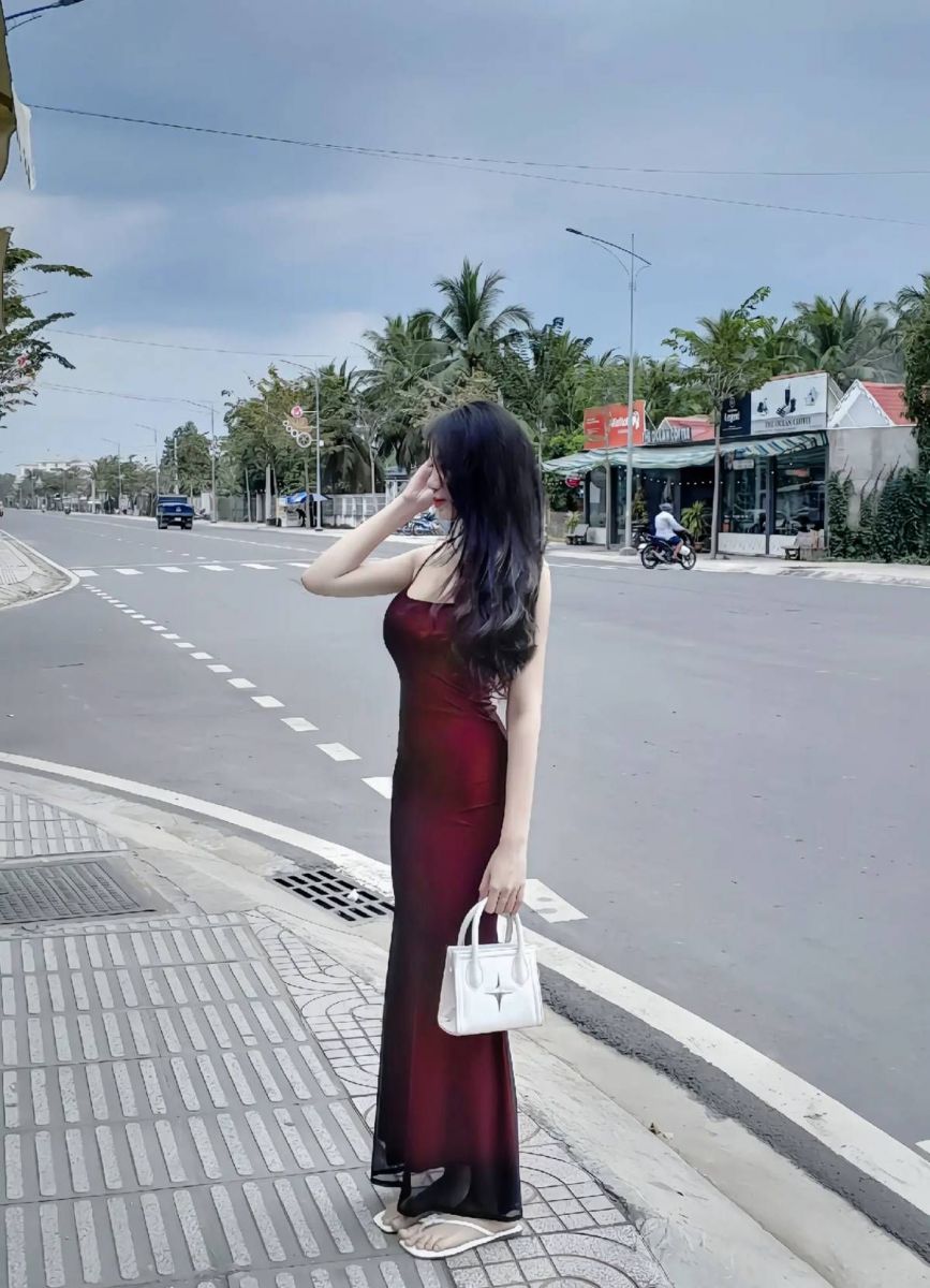 Cô gái xinh đẹp trong chiếc váy dài màu đỏ trên phố Tây