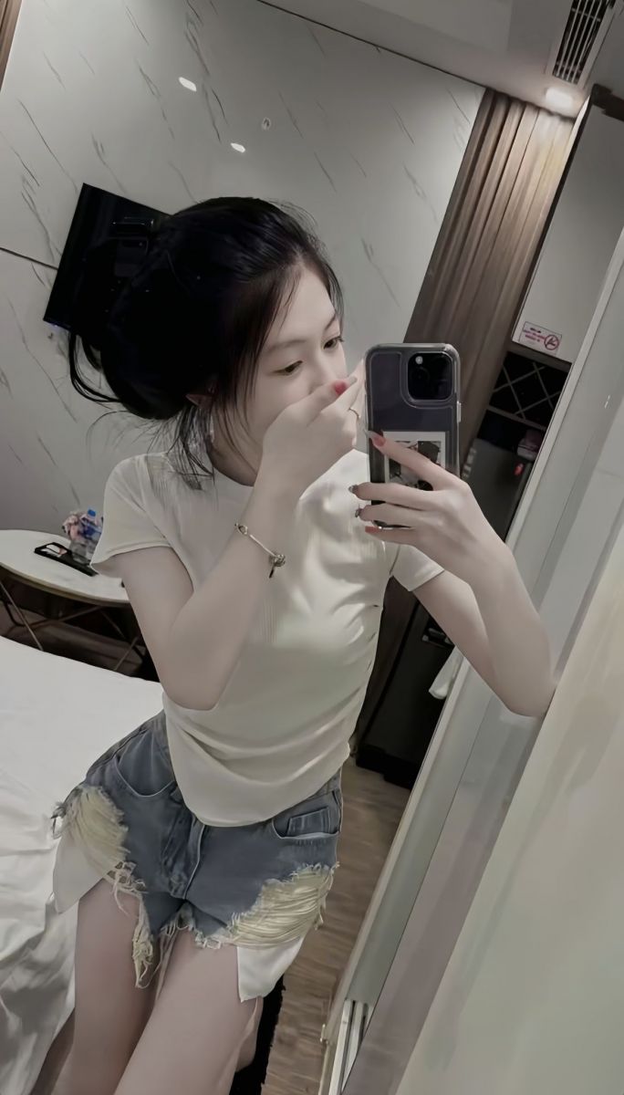 Cô gái xinh đẹp với áo phông trắng và quần sooc ngắn