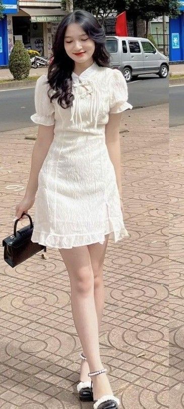 Cô gái xinh mặc váy trắng dịu dàng bên phố