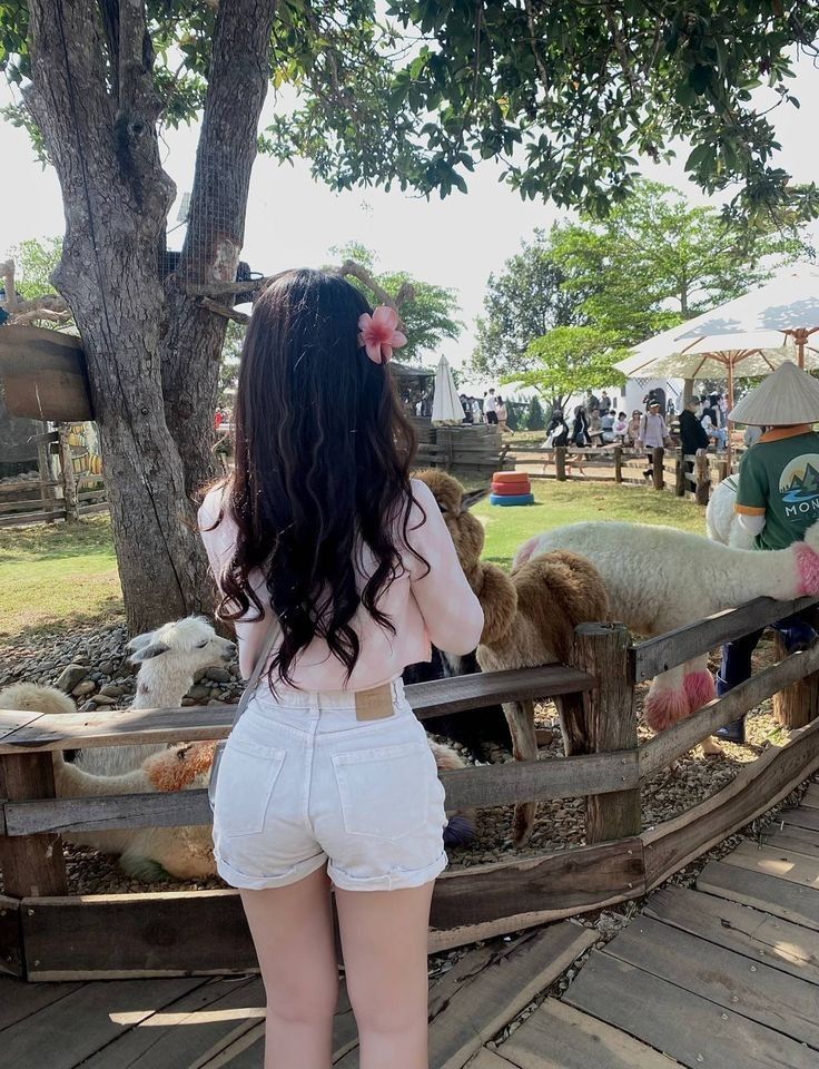 Gái xinh mặc áo hồng và quần shorts trắng trong không gian thoáng đãng