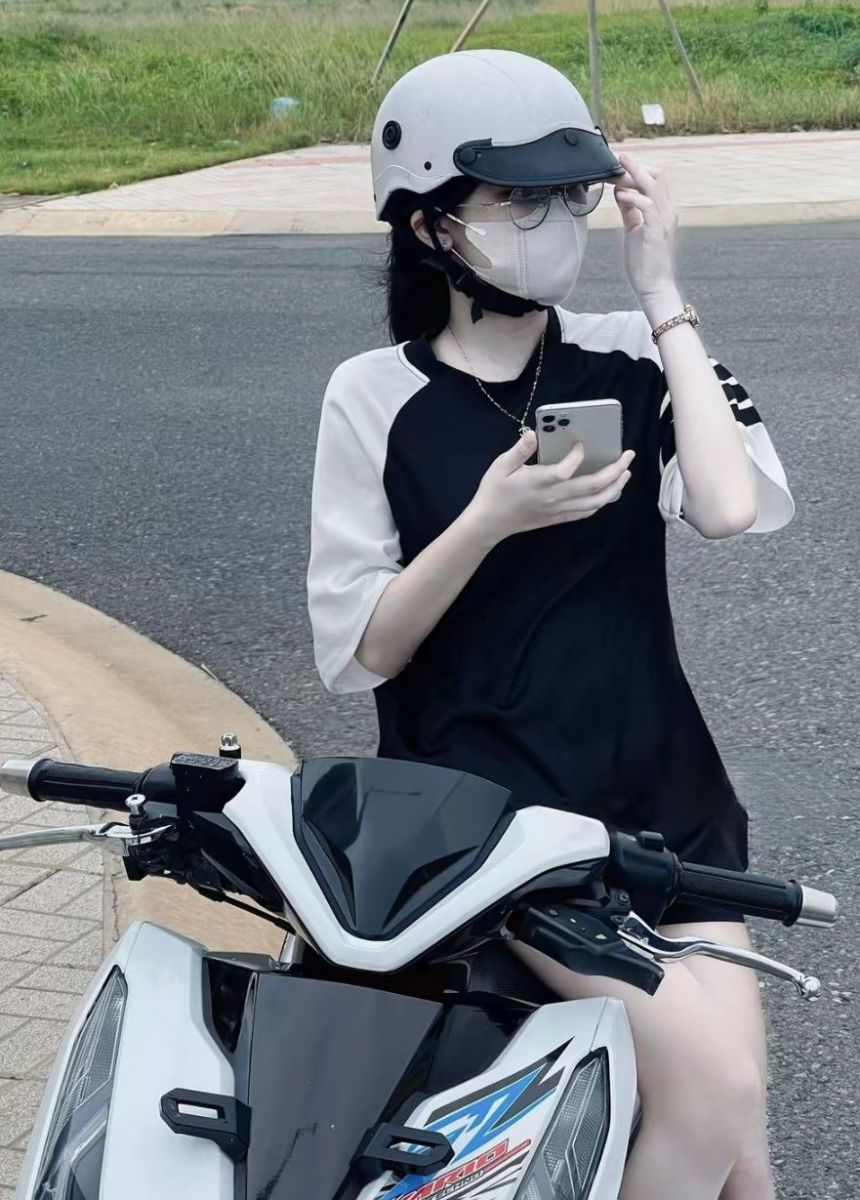 Gái xinh mặc áo thun đen trắng trên xe máy