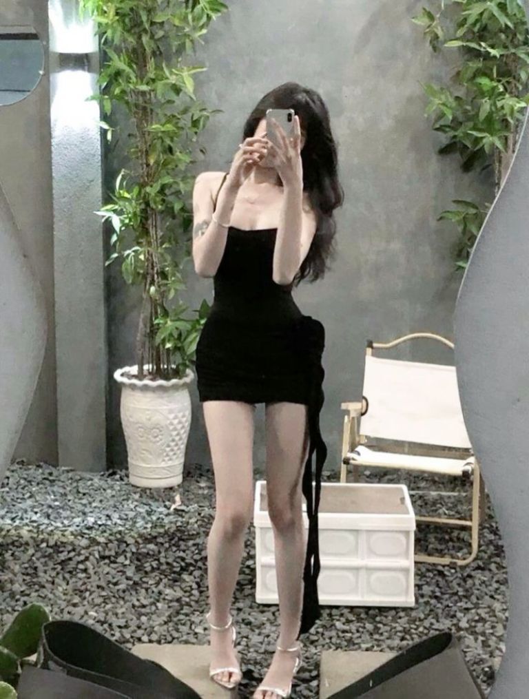Gái xinh mặc đầm ôm màu đen chụp selfie trong không gian hiện đại