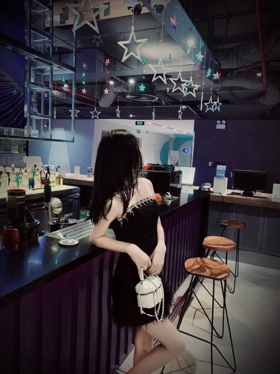 Gái xinh mặc váy đen quyến rũ bên quầy bar