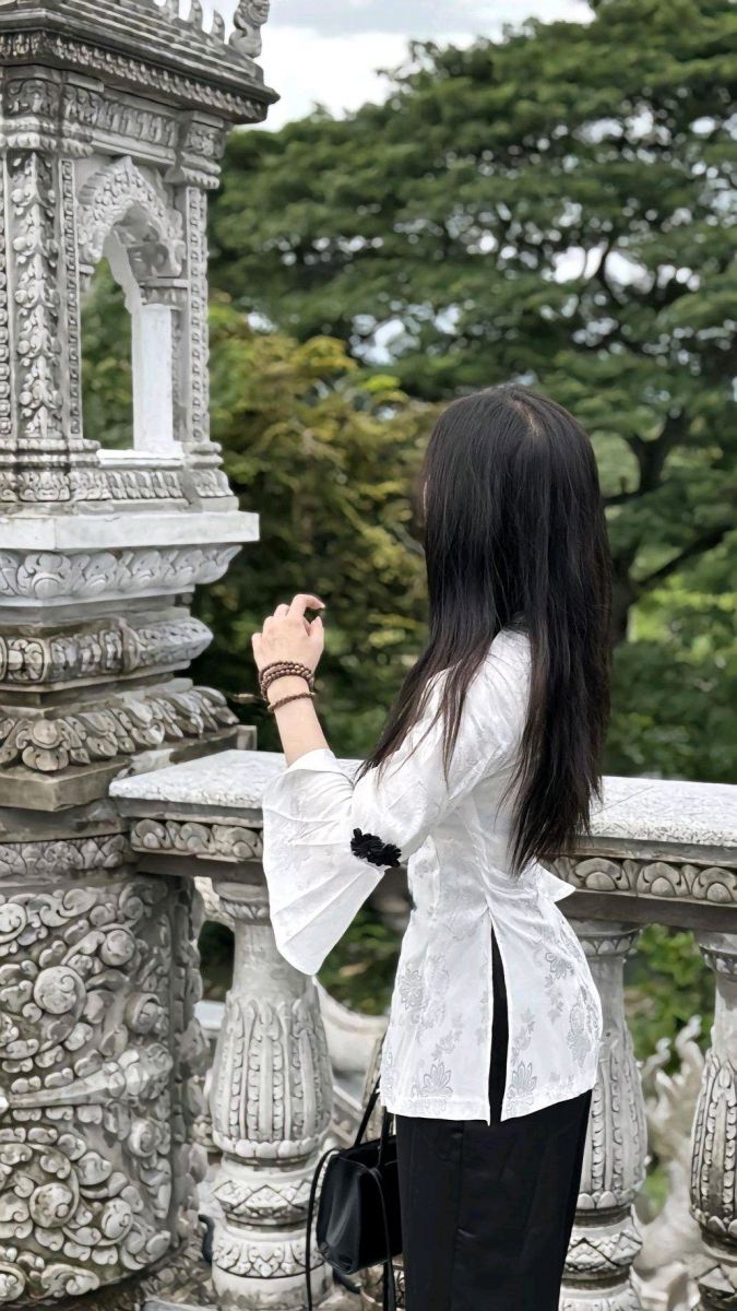 Ảnh cô gái đứng bên cạnh công trình kiến trúc cổ