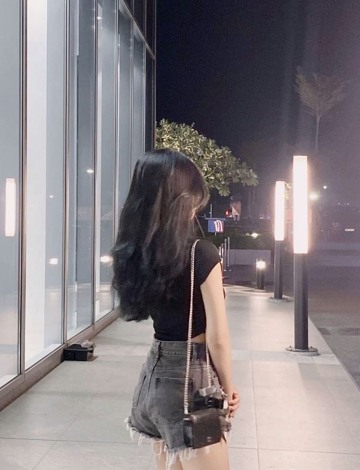 Cô gái trẻ mặc áo phông đen và quần short