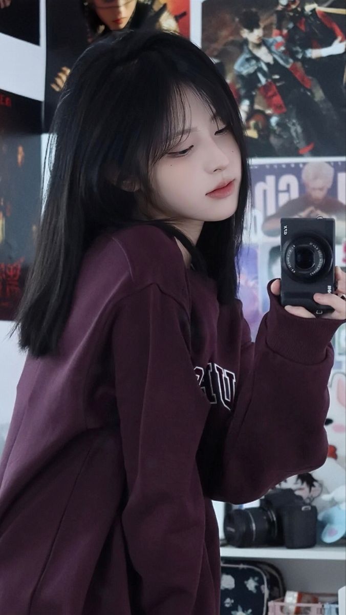 Cô gái trẻ trong áo sweatshirt tím chụp ảnh tự sướng