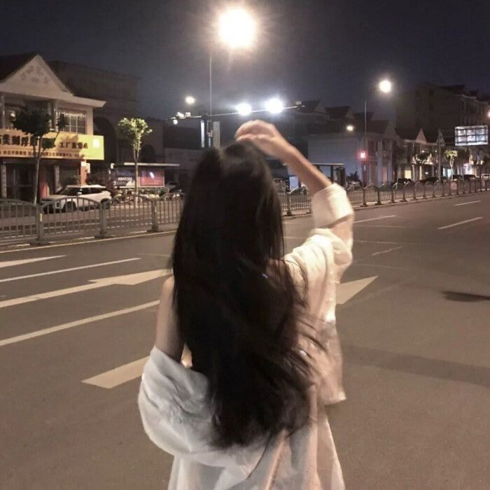 Cô gái xinh mặc áo sơ mi trắng giữa phố