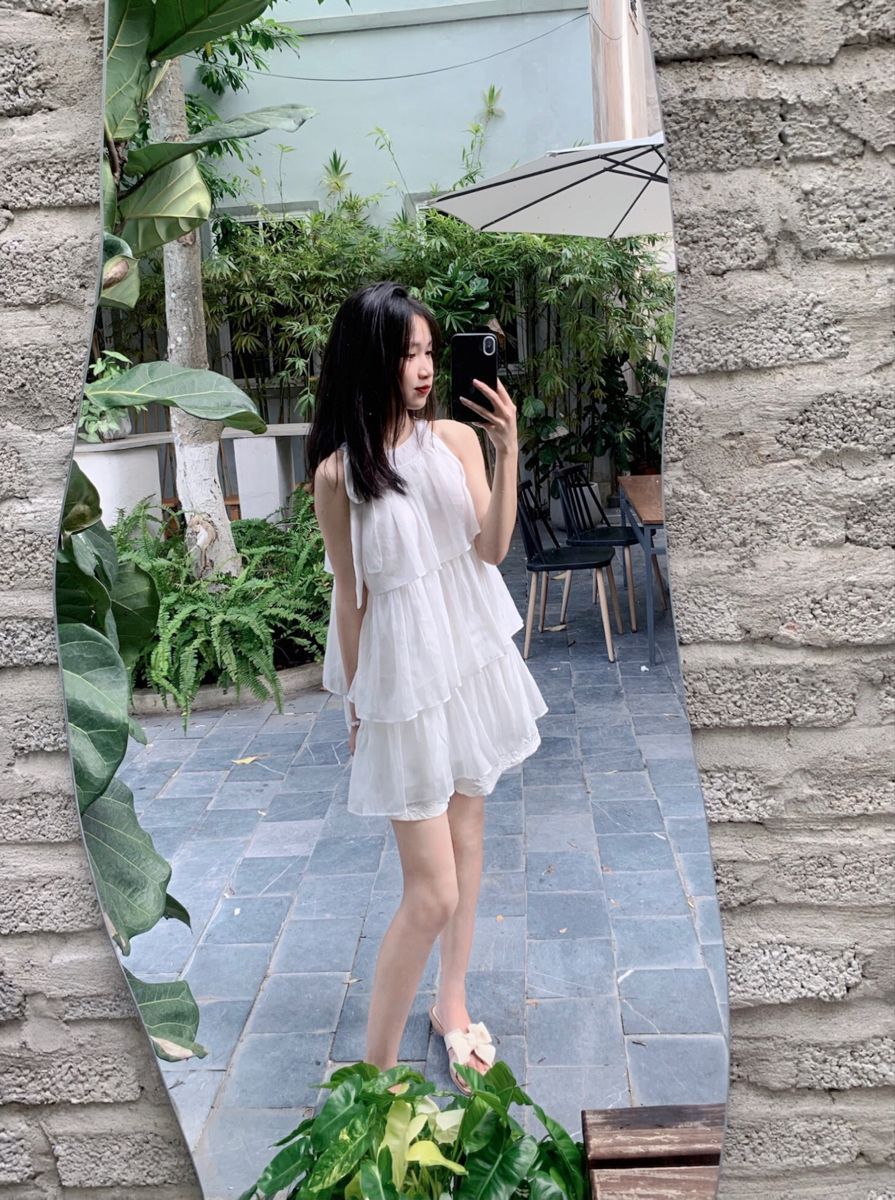 Cô gái mặc đầm trắng tạo dáng chụp ảnh selfie giữa rừng cây xanh