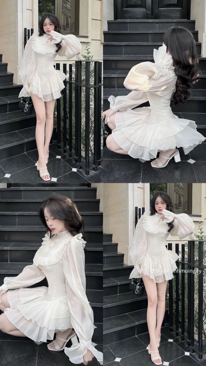 Cô gái xinh đẹp mặc váy trắng trên bậc thang