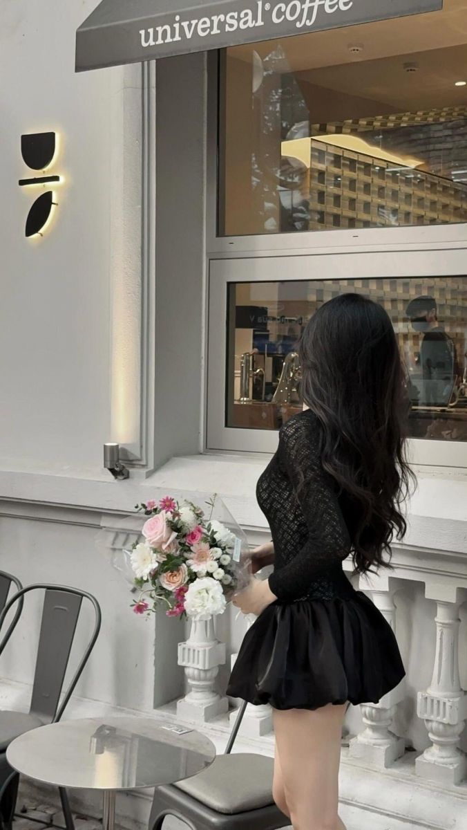 Gái đẹp mặc váy đen và áo lưới cá tính trước quán cà phê