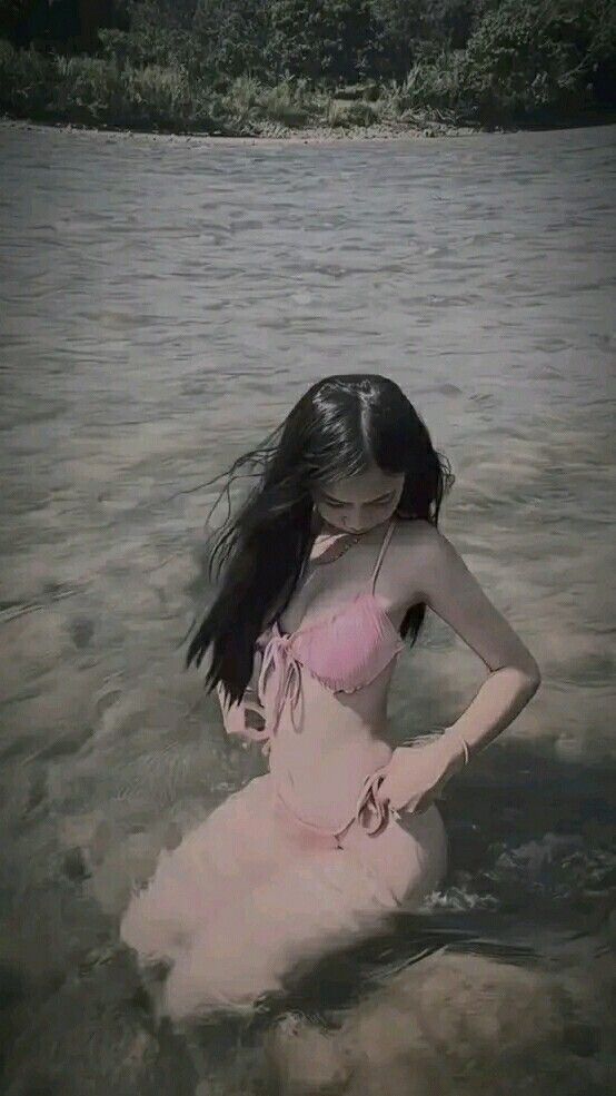 Gái xinh mặc bikini hồng ngồi bên bờ sông