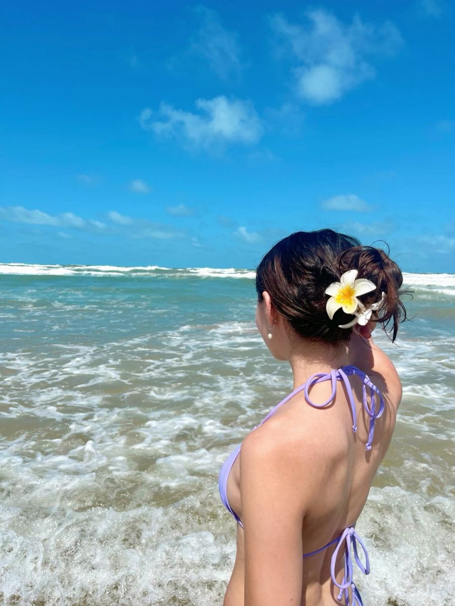 Gái xinh mặc bikini màu tím giữa biển, nụ cười nhẹ nhàng